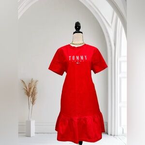 Red T-shirt dress with Tommy Hilfiger logo. Short sleeves and a ruffled bottom.